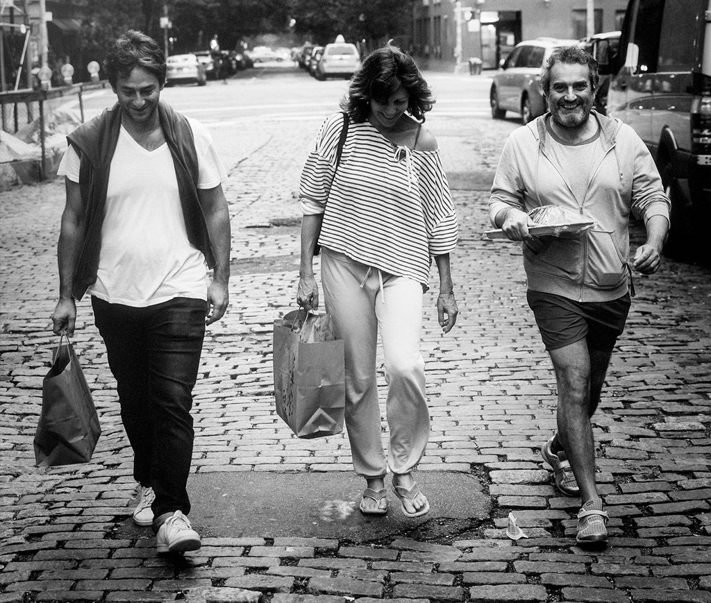 Founders of il Buco Vita walking on a cobblestone street 
                  